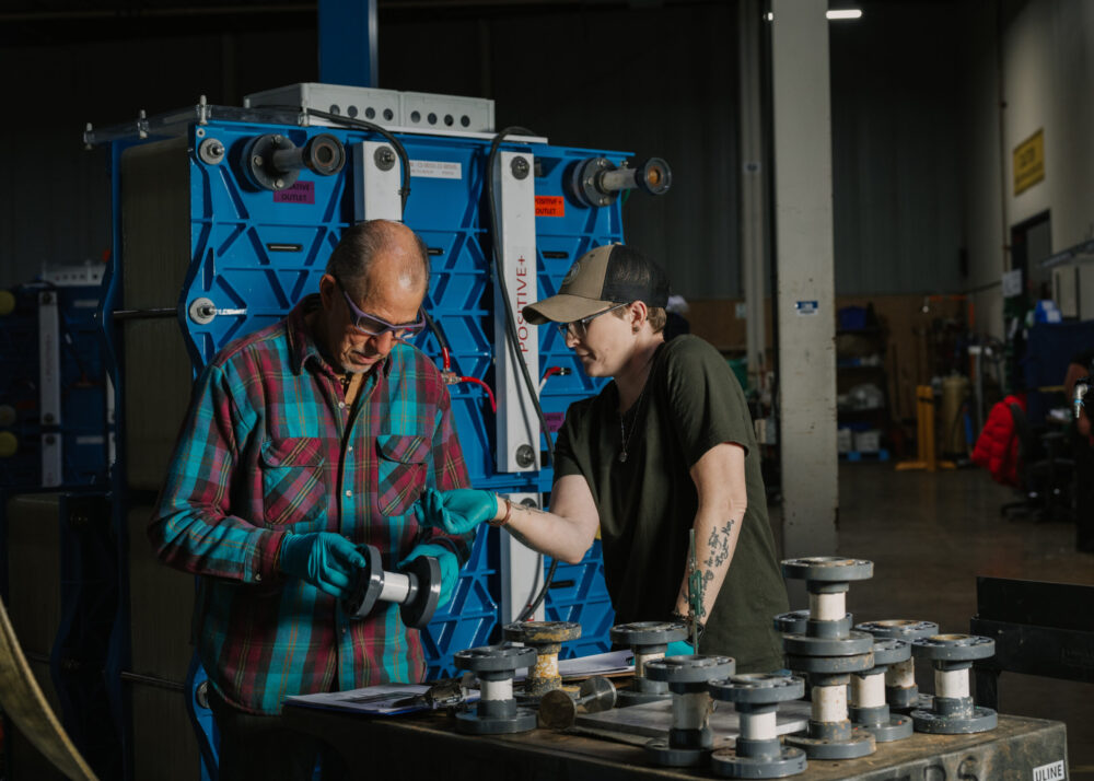 ESS battery manufacturing Two colleagues working together to build ESS iron flow batteries img